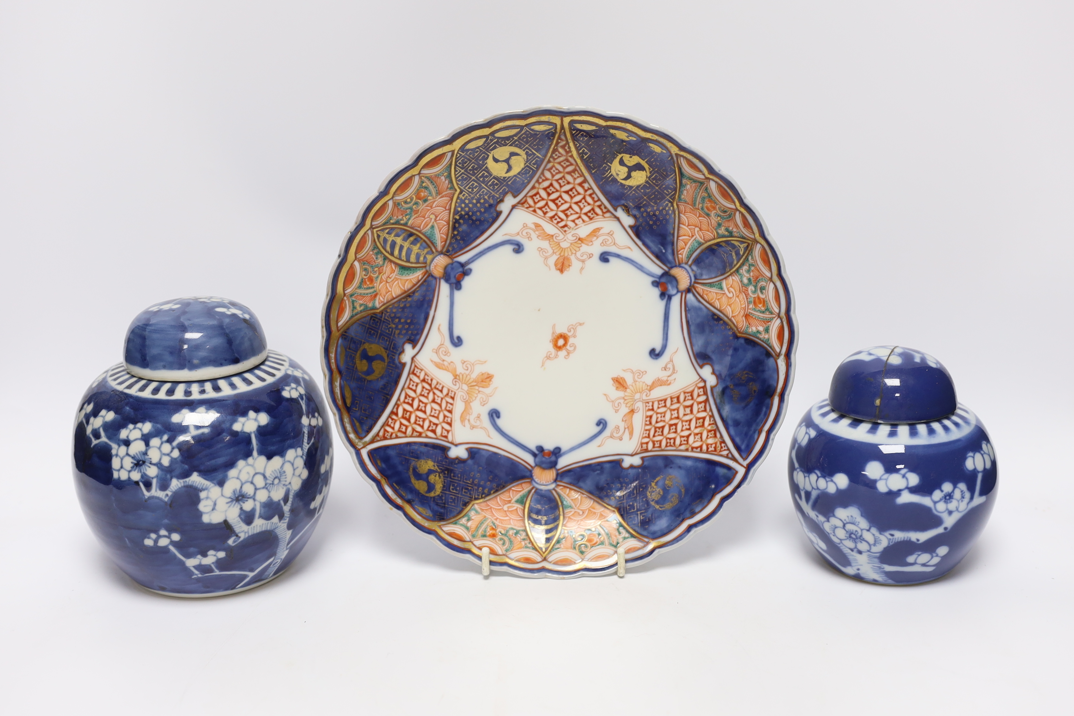 An early 20th century Chinese blue and white vase and cover, pair of 19th century Chinese famille rose dishes, four prunus jars, two covers, a Japanese Meiji period Imari dish and a small satsuma pot, some damage, talles